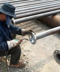 Worker installing Carbon Steel Slip On Flange Three Quarters Inch With Neck Forged Raised Face Class 150 for industrial piping
