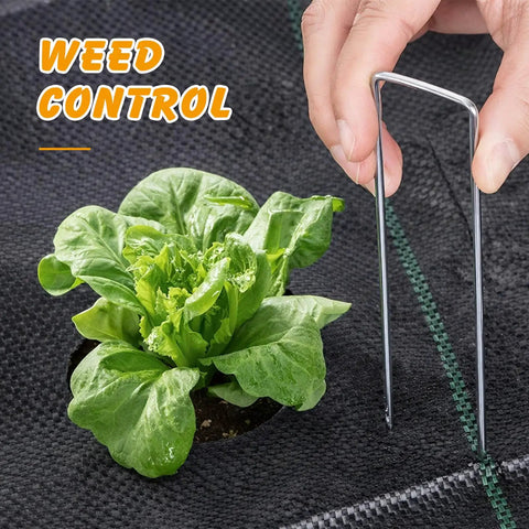 Weed Barrier Landscape Fabric 4 Foot By 100 Foot Woven Ground Cover For Gardening And Landscaping 3.2 Oz UV Resistant Polypropylene being used with U Shaped Stake