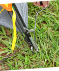 Close-up of All In One Heavy Duty Tent Stake Puller Tool Set for Camping and Outdoor Use Peg Remover and Hook Extractor in action