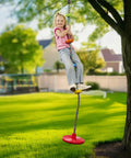 Child enjoying Kids Tree Swing With Disc Seat And Rainbow Climbing Rope Set Including Carabiner And 2.6 Foot Strap outdoors