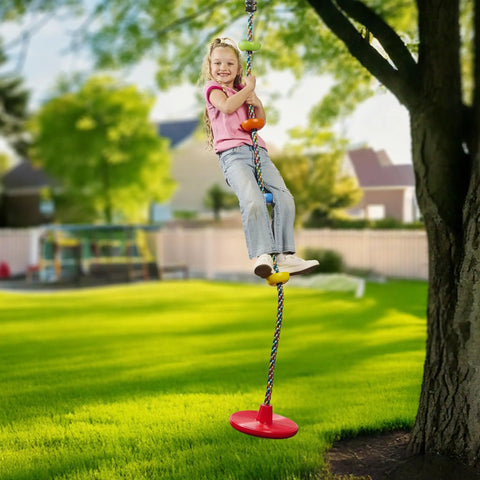 Child enjoying Kids Tree Swing With Disc Seat And Rainbow Climbing Rope Set Including Carabiner And 2.6 Foot Strap outdoors