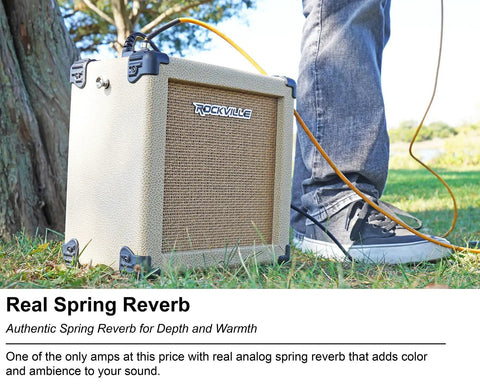 G-Charge 20 Battery Powered Guitar Amplifier With 6.5 Inch Speaker positioned outdoors on grass next to musician's legs