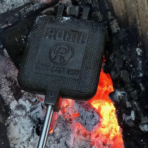 Square Cast Iron Pie Iron Sandwich Cooker For Campfire Cooking And Backyard BBQ over campfire flames