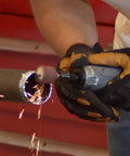 Tough As Nails Straight Pneumatic Die Grinder in use, grinding steel pipe, generating sparks and fine dust, showcasing ergonomic grip.