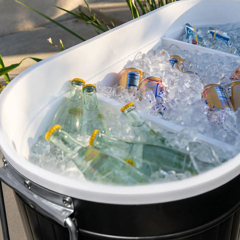 Close-up of 120-Qt Rolling Ice Chest Cooler Cart With Wheels holding bottles and cans in ice, black exterior visible.
