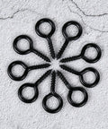 10 Pack Tough As Nails M6 Eye Screws 2.2 Inch Black Heavy Duty Carbon Steel Self Tapping Screw Eye Hooks arranged in a circle.