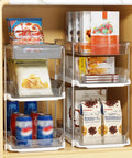 Total Game Changer Clear Three Tier Under Sink Organizer Two Pack with snacks and drinks stacked in smooth glide bins.