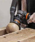 Heavy Duty Power Carving Tool Attachment Featuring A Slick Two Inch Cutting Disc And Adjustable Sanding System in use on wood.