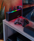 GX950UC Gaming UPS Battery Backup And Surge Protector for PCs with RGB lighting next to gaming setup on desk