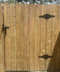 Heavy Duty Eight Inch Fence Gate Hinges With Matte Black Steel Finish for Outdoor Wood Fences and Sheds on a wooden gate.