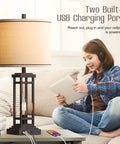 27.5 Inch Tall Farmhouse Table Lamps Set Of 2 With USB C And USB A Charging Ports Rustic Industrial Black End Table Lamps For Bedroom Living Room Nightstand Oil Rubbed Bronze Finish shown with a young person charging devices.