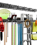 Must Have 48 Inch Heavy Duty Wall Tool Organizer Rack With Six Hooks For Shovels Rakes Garden Tools And Lawn Gear Stud Friendly 16 Inch Center Mounting shown in use, holding various tools in a garage.