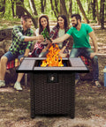 30 Inch Wicker Patio Fire Pit Table With Fire Glass For Outdoor Parties And Gatherings surrounded by friends in a forest setting