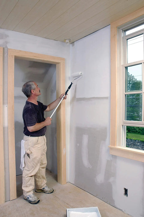 Man applying Mold And Mildew Proof Interior Paint With Self Priming Formula Eggshell White Finish on wall with roller