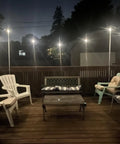 Ambience Pro 48 Ft Solar Outdoor String Lights With 15 Shatterproof 1W LEDs illuminating a cozy patio deck at night