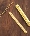 Antique Bronze Decorative Hinges for Wooden Boxes and Cabinets 2 Pack Butt Hinges 100mm by 9mm with screws on wood surface