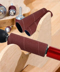 Handheld Rubber Sanding Drum Set With 120 Grit Sleeves with drill attachment on wood surface showcasing sanding sleeves.