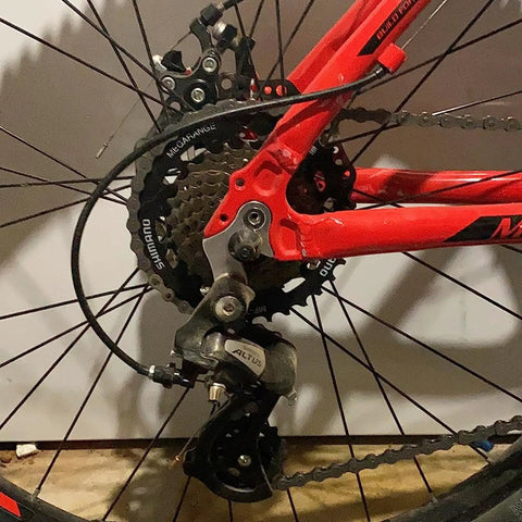 Close-up of a bike featuring Universal Bicycle Derailleur Hanger Replacement 2 Pack Frame Gear Tail Hook in use on a mountain bike.