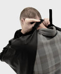 Person adjusting Heavy Duty Butchering Apron With Full Arm Coverage, Waterproof Vinyl Material, Elastic Cuffs, One Size, Black