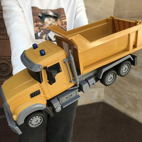 Child holding Remote Control Dump Truck Toy For Kids With 6 Channel Radio Control And Bright LED Lights Totally Cool Realistic RC Construction Vehicle