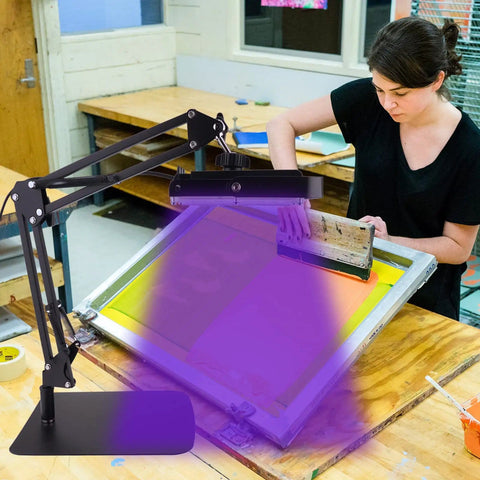 Woman screen printing using 60W UV screen printing exposure light with adjustable stand pro grade kit for photo emulsion and cyanotype work.