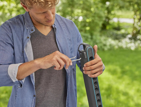 Person using tools on Ditch The Mess With This Slick Wall Rack Built For Garden Tools And Hand Pruners.