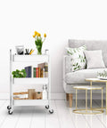 Three Tier Rolling Metal Storage Organizer On Wheels White Mobile Utility Cart With Caster Wheels near sofa in living room