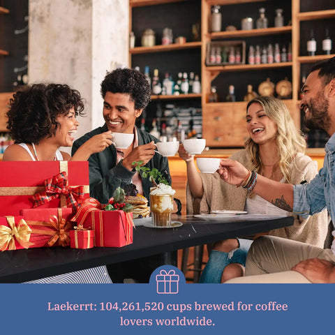 Group of friends enjoying coffee around a table with gift boxes in a cozy cafe setting