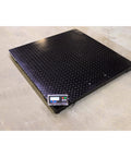 Built Like A Tank Heavy Duty Industrial Floor Scale With Printer digital pallet scale on a textured steel deck, 48x48 inch size.