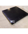 Heavy Duty Industrial Floor Scale Digital Pallet Weigher Warehouse Shipping Workhorse Accurate Readouts Reliable 1000 Pound Capacity Four Foot Square Platform close-up on textured surface and display.