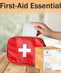 Box of Bordered 2x2 Sterile Adhesive Gauze Pads next to first-aid kit, hand holding a gauze pad, for wound protection.