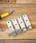 Buttery Smooth 4 Pack Sliding Door Pulley Wheels With Silent Rubber Bottom Rollers And Rock Solid Construction For Easy Side Mount Closet Barn Door Track Hardware Replacement, silver rollers on wooden surface.
