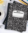 Bulk 50 Pack Composition Notebooks With Hard Covers, College Ruled, 200 Pages Each, 9.75 by 7.5 Inches, Black Marble Journal on desk