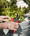 ComfortGEL Bypass Hand Pruner With Three Quarters Inch Cut Capacity Red Handle trimming plant stems in garden