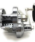 Blue Heaven BH L80 Hi Lo Saltwater Jigging Reel For Big Game Angling Five Point Nine To One Gear Ratio Forty Four And A Half Inches Retrieve L Shape Drag Lever Pro Grade Heavy Duty Offshore Tuna Jigging Gear in silver, side view