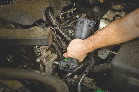 Person using Close Quarter Drill With Non Slip Grip 3.5 Amp Motor Variable Speed 0 To 1600 RPM Three Eighths Inch Chuck in tight engine space