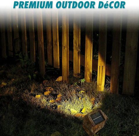 Solar Rock Lights For Garden Pathways Four Pack illuminating fence, solar spotlight, realistic stone look, outdoor yard use