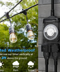 Ultimate Workhorse Outdoor Timer With 2 Grounded Outlets And Heavy Duty Waterproof Shell Built To Handle Pool Pumps, Christmas Lights, And Garden Irrigation While Offering 24 Hour Timing Options Plus ETL Safety Listing In Sleek Black Exterior with two bulbs hanging in the rain.