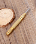 Automatic Center Punch Tool With HSS Tip Spring Loaded Brass Body No Hammer Needed For Precise Marking In Wood And Metal One Eighth Inch Roll Pin Punch Set Self Centering No Slip Durable Pro Grade Quality Ready To Roll on wooden surface.