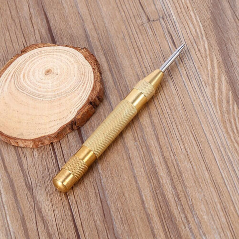 Automatic Center Punch Tool With HSS Tip Spring Loaded Brass Body No Hammer Needed For Precise Marking In Wood And Metal One Eighth Inch Roll Pin Punch Set Self Centering No Slip Durable Pro Grade Quality Ready To Roll on wooden surface.