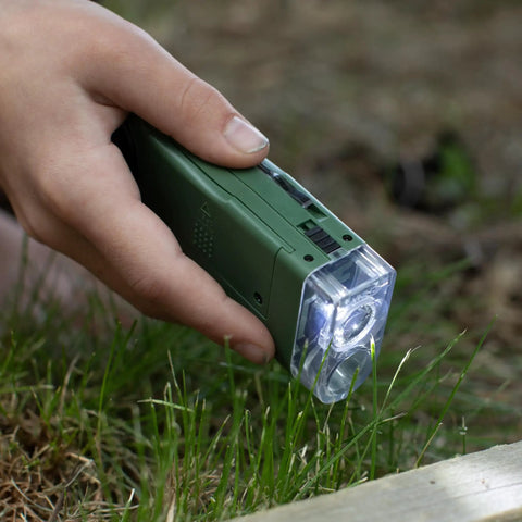 Kid Explorer 7 Function Optical Pocket Tool With 30x Microscope, 8x Telescope, 9x Fold Out Magnifier, Built In Flashlight, Signal Whistle, Compass And Digital Clock, Totally Fun Hands On Learning Gift For Curious Kids in hand outdoors