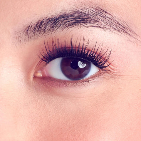 Close-up of an eye with Complete DIY Eyelash Extensions Starter Kit With Bond And Seal, Precision Applicator, natural rounded wisps