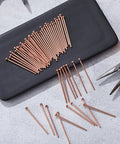 Bulk Pack Of 500 Welding Studs And Stud Welder Pins for auto body spot welding on black surface with tools visible