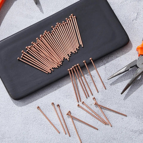 Bulk Pack Of 500 Welding Studs And Stud Welder Pins for auto body spot welding on black surface with tools visible