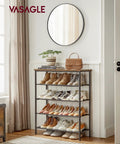 Solid Multi Tier Shoe Rack Storage Organizer Holds Twelve To Sixteen Pairs With Reinforced Steel Frame And Durable Fabric Shelves in entryway with shoes and boots.