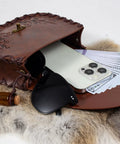 Vintage Brown Faux Leather Medieval Belt Pouch Featuring Carved Elven Leaf Details with a phone, money, and sunglasses.