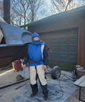 Sandblasting Hood And Helmet With Safe Air Feed Shoulder Protection For Sandblasters Durable ABS Mask With Double Lens Protection And Five Outer Lenses Ideal For Sand Blasting Equipment And Heavy Duty Projects shown being used outdoors by a person