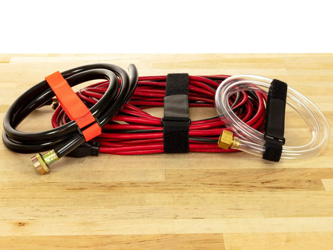 Pro Grade Reusable Hook And Loop Cinch Straps For Cables And Cords, organizing wires and hoses on wooden table.