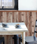 Cinnamon Wood Peel And Stick Wallpaper Self Adhesive Faux Wood Plank for kitchen decor behind a white table with cups