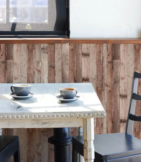 Cinnamon Wood Peel And Stick Wallpaper Self Adhesive Faux Wood Plank for kitchen decor behind a white table with cups